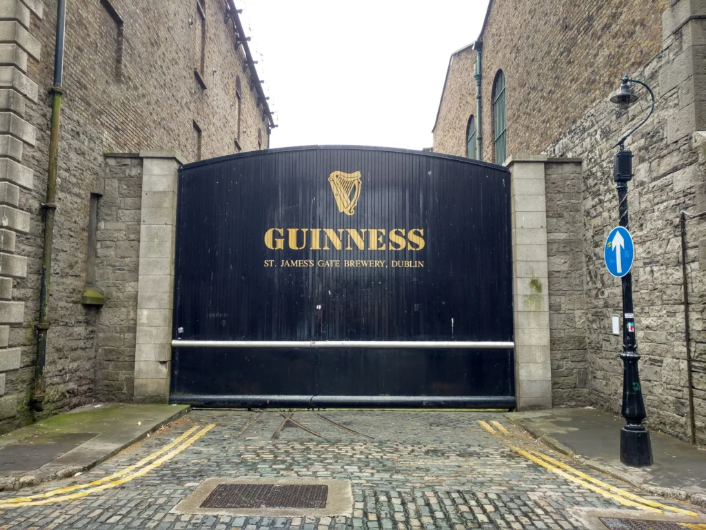 Guinness Brewery ((Image Source: Photo by <a href="https://unsplash.com/@scho_and?utm_content=creditCopyText&utm_medium=referral&utm_source=unsplash">Andrew Meßner</a> on <a href="https://unsplash.com/photos/a-guinness-sign-in-front-of-a-brick-building-3Doz7HCto-E?utm_content=creditCopyText&utm_medium=referral&utm_source=unsplash">Unsplash</a>
  )