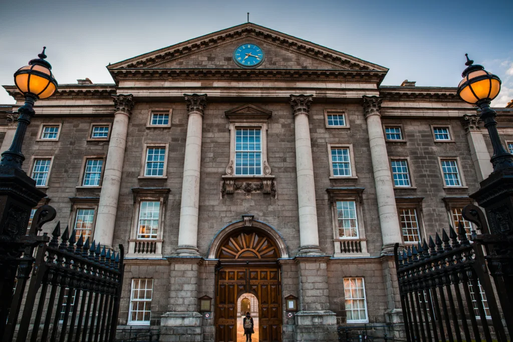 Trinity College (Image Source: Photo by <a href="https://unsplash.com/@steve_?utm_content=creditCopyText&utm_medium=referral&utm_source=unsplash">Stephen Bergin</a> on <a href="https://unsplash.com/photos/gray-and-white-concrete-building-jEQydmwFlFM?utm_content=creditCopyText&utm_medium=referral&utm_source=unsplash">Unsplash</a>
  )